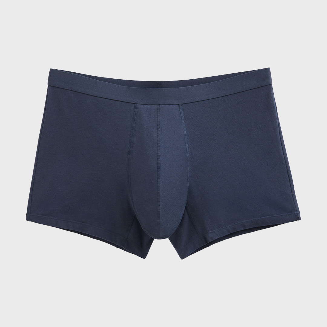 Boxer absorbant lavable homme, offrant protection contre fuites légères. Conçu en coton biologique avec ceinture anti-roulement, semblable aux sous-vêtements classiques.